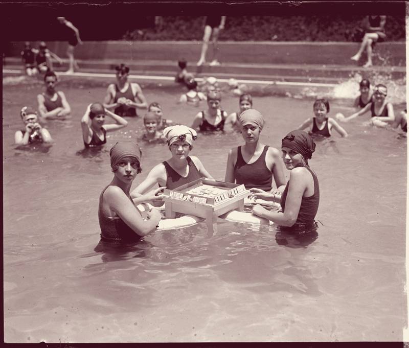 Four women playing mahjong in a pool, Washington, 1924